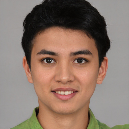 Joyful asian young-adult male with short  brown hair and brown eyes