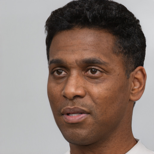 Neutral black adult male with short  black hair and brown eyes