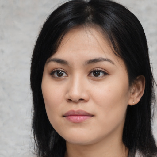 Joyful asian young-adult female with long  black hair and brown eyes