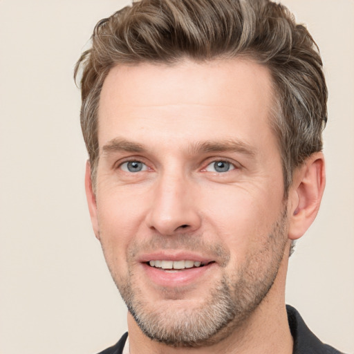 Joyful white adult male with short  brown hair and grey eyes