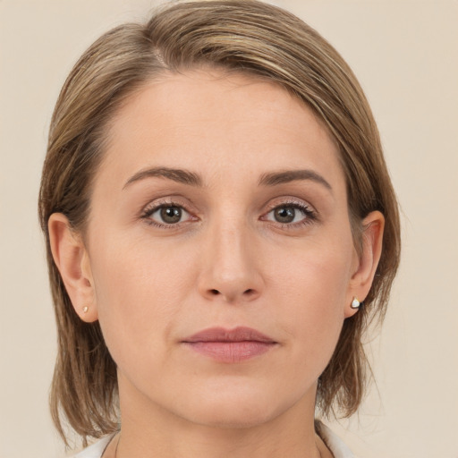 Joyful white young-adult female with medium  brown hair and grey eyes