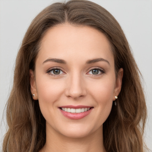 Joyful white young-adult female with long  brown hair and grey eyes