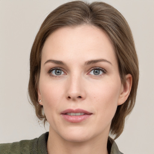 Joyful white young-adult female with medium  brown hair and grey eyes