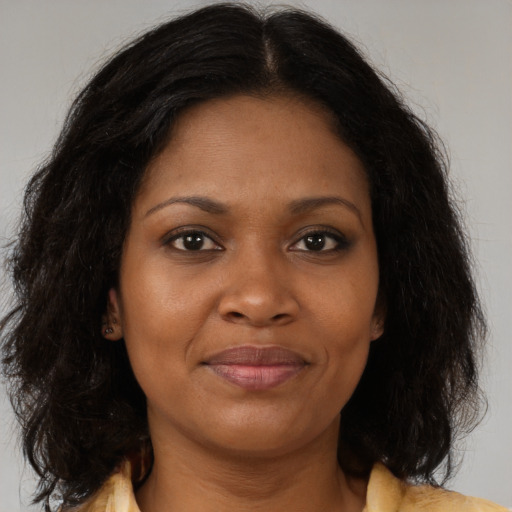Joyful black young-adult female with medium  brown hair and brown eyes