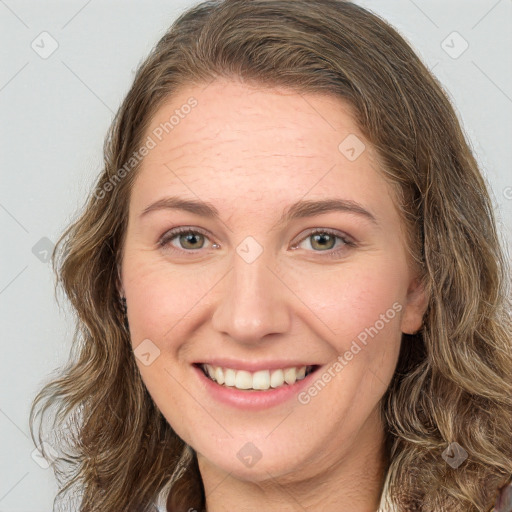 Joyful white young-adult female with long  brown hair and green eyes