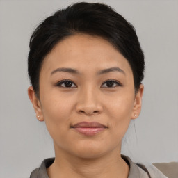 Joyful asian young-adult female with short  black hair and brown eyes