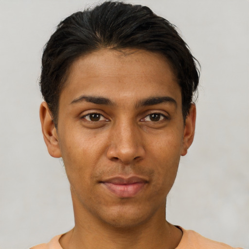 Joyful latino young-adult male with short  black hair and brown eyes