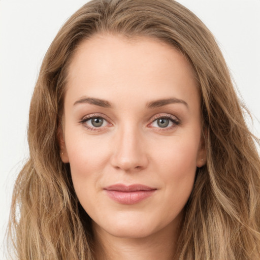 Joyful white young-adult female with long  brown hair and green eyes