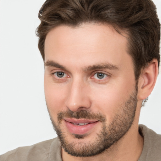 Joyful white young-adult male with short  brown hair and brown eyes