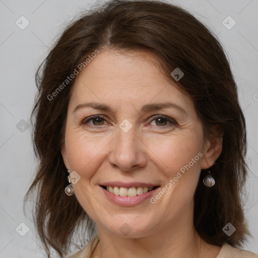 Joyful white adult female with medium  brown hair and brown eyes