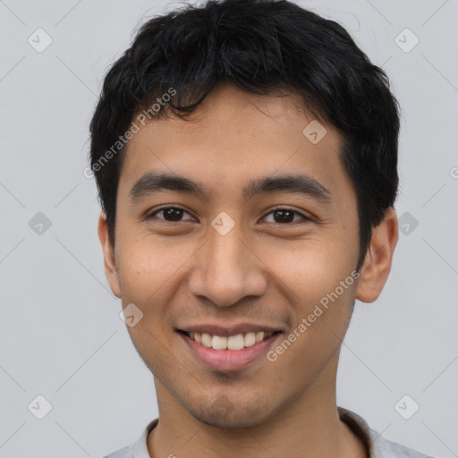 Joyful asian young-adult male with short  black hair and brown eyes