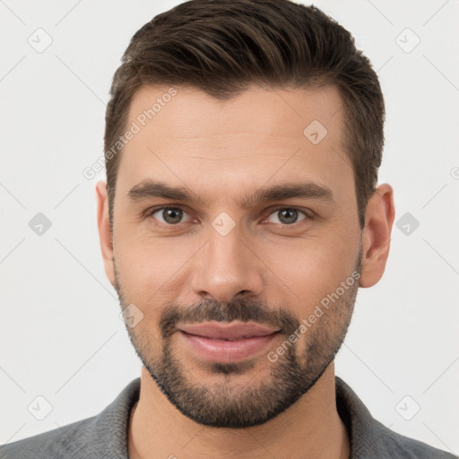 Joyful white young-adult male with short  brown hair and brown eyes