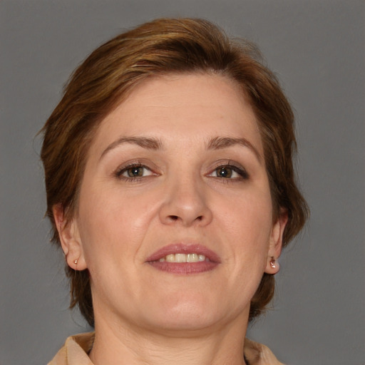 Joyful white adult female with medium  brown hair and brown eyes