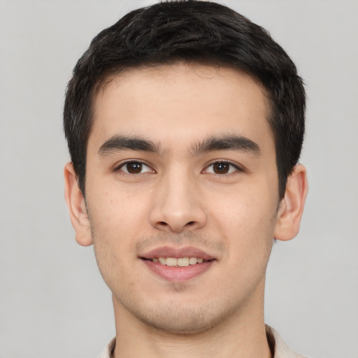 Joyful white young-adult male with short  black hair and brown eyes