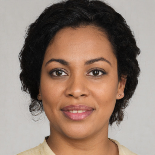 Joyful latino young-adult female with medium  black hair and brown eyes