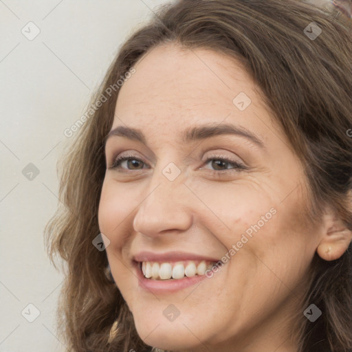 Joyful white adult female with long  brown hair and brown eyes