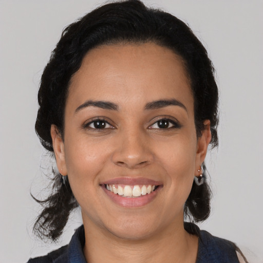 Joyful latino young-adult female with medium  black hair and brown eyes