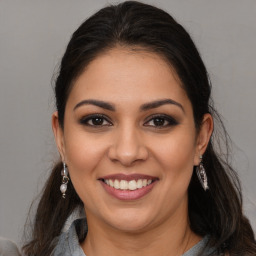 Joyful white young-adult female with long  brown hair and brown eyes