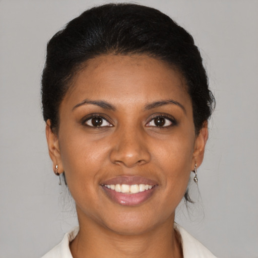 Joyful black young-adult female with medium  brown hair and brown eyes