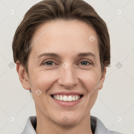 Joyful white adult female with short  brown hair and grey eyes