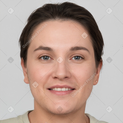 Joyful white young-adult female with short  brown hair and grey eyes