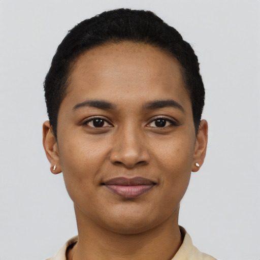 Joyful black young-adult female with short  black hair and brown eyes