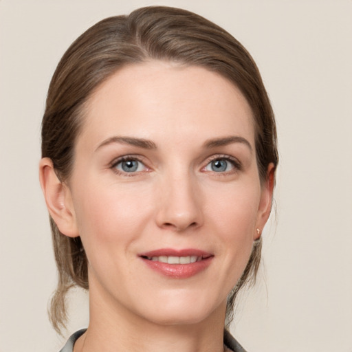 Joyful white young-adult female with medium  brown hair and grey eyes