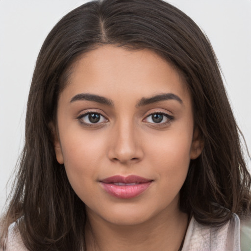 Joyful white young-adult female with long  brown hair and brown eyes