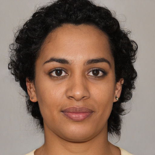 Joyful latino young-adult female with medium  black hair and brown eyes