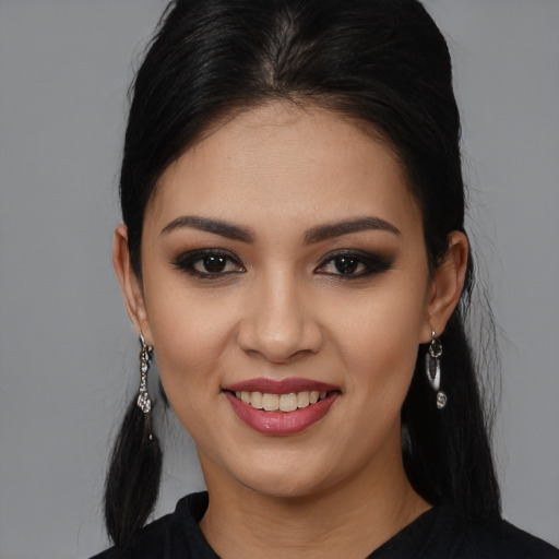 Joyful white young-adult female with long  black hair and brown eyes