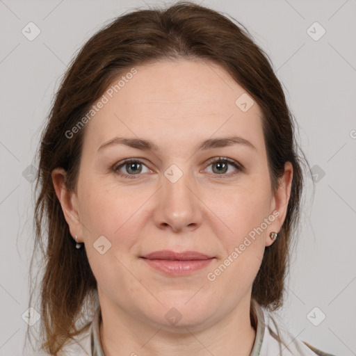 Joyful white adult female with medium  brown hair and grey eyes