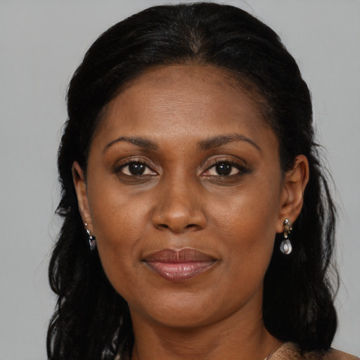 Joyful black adult female with medium  brown hair and brown eyes