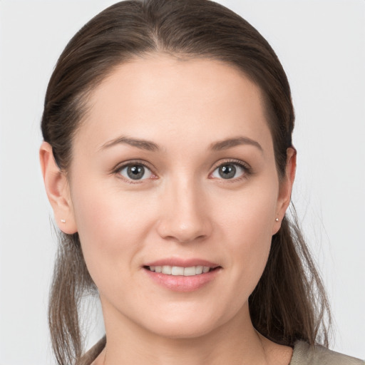 Joyful white young-adult female with medium  brown hair and brown eyes