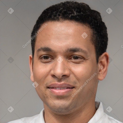 Joyful latino young-adult male with short  brown hair and brown eyes