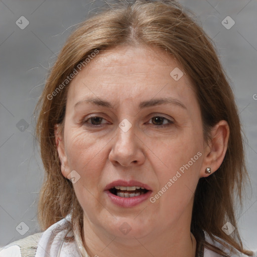 Joyful white adult female with medium  brown hair and brown eyes