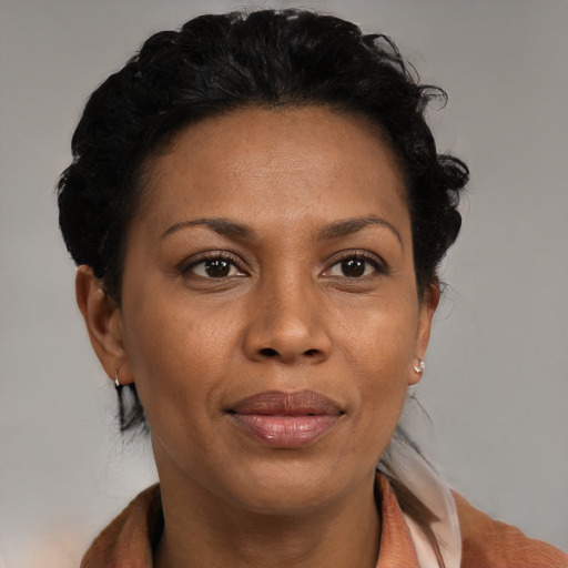 Joyful black adult female with medium  brown hair and brown eyes