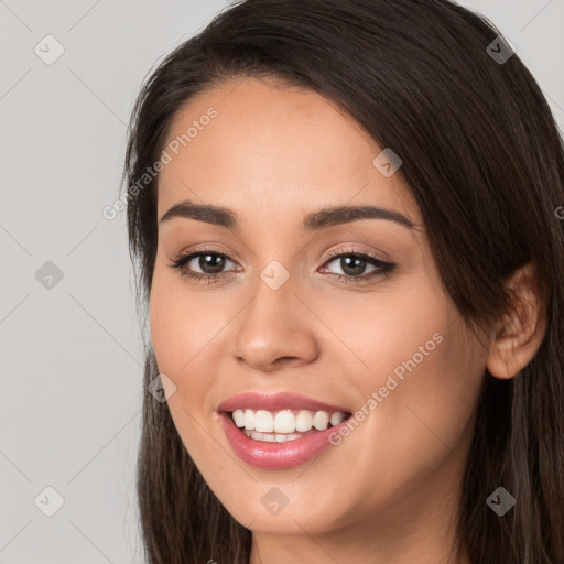 Joyful white young-adult female with long  brown hair and brown eyes