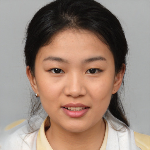 Joyful asian young-adult female with medium  brown hair and brown eyes