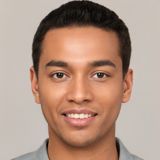 Joyful white young-adult male with short  black hair and brown eyes