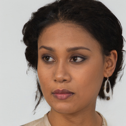 Neutral black young-adult female with medium  brown hair and brown eyes