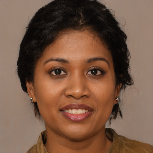 Joyful black young-adult female with medium  brown hair and brown eyes