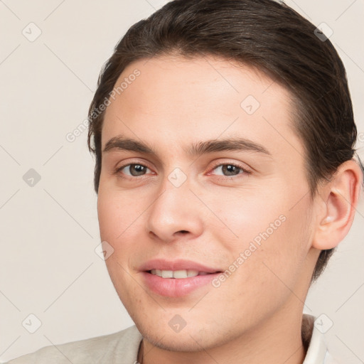 Joyful white young-adult male with short  brown hair and brown eyes