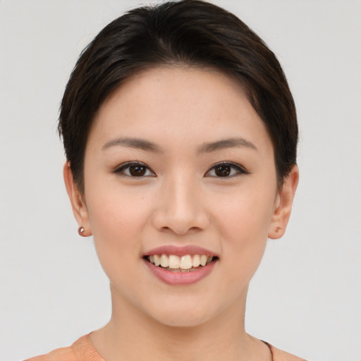 Joyful asian young-adult female with short  brown hair and brown eyes