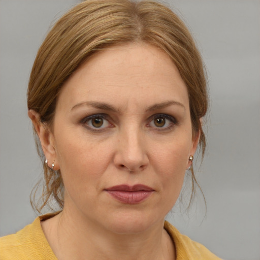 Joyful white adult female with medium  brown hair and blue eyes