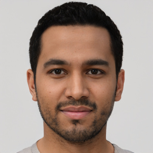 Joyful latino young-adult male with short  black hair and brown eyes