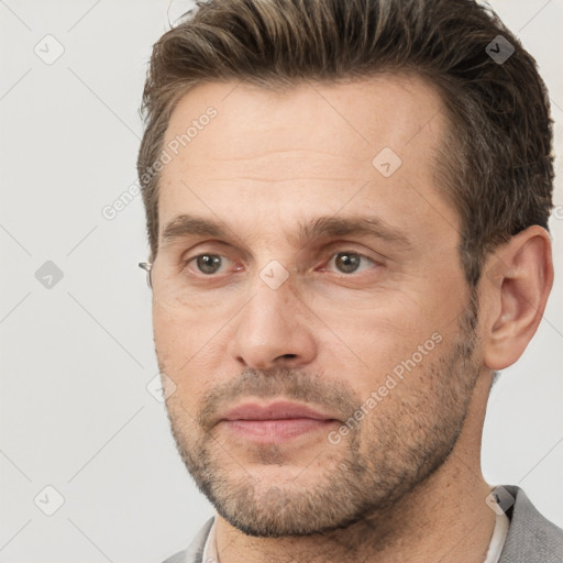 Joyful white adult male with short  brown hair and brown eyes