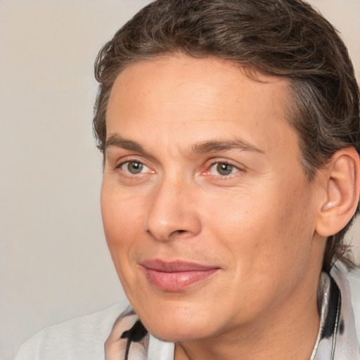 Joyful white adult male with medium  brown hair and brown eyes