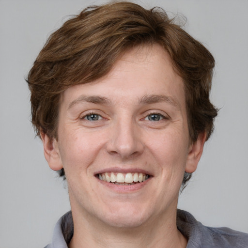 Joyful white adult male with medium  brown hair and grey eyes