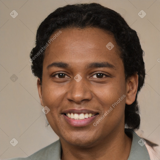 Joyful black young-adult male with short  black hair and brown eyes