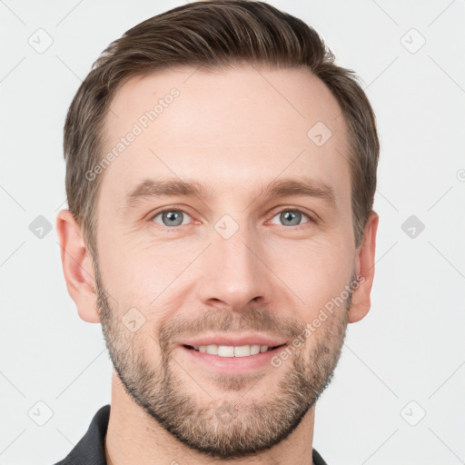 Joyful white young-adult male with short  brown hair and grey eyes